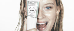 Girl with the coconut body balm tube covering half her face