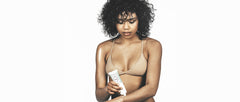 woman applying coconut body balm onto arm