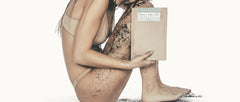 Girl sitting down with coffee scrub on body