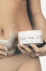 Girl massaging body cream onto stomach