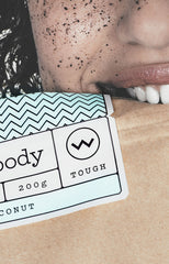 Girl biting coffee scrub packet