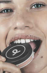 Girl biting into lip duo scrub container