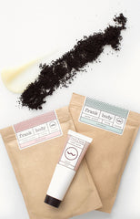 Girls with coffee scrub on their face and holding frank body products