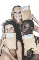 Girls biting into body balm tube