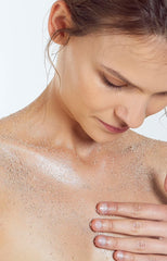 Girls rubbing coffee scrub on face